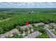 Drone shot showing townhomes backed by a lush forest, ideal for nature lovers at 8132 Stone Path Way, Tampa, FL 33647