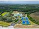 Aerial shot shows the clubhouse with tennis and sand courts along with the neighborhood pool at 8132 Stone Path Way, Tampa, FL 33647