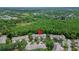 Drone shot shows townhomes and a large, scenic forest, ideal for peaceful living at 8132 Stone Path Way, Tampa, FL 33647