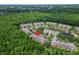 Aerial view shows the community with pond and lush tree surroundings, ideal for nature lovers at 8132 Stone Path Way, Tampa, FL 33647