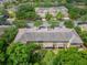 Aerial shot shows the building's back patios with trees, street, and lush landscaping at 8132 Stone Path Way, Tampa, FL 33647