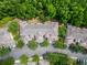 Drone shot shows building rooftops with trees, parking, and lush landscaping at 8132 Stone Path Way, Tampa, FL 33647