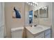Bright bathroom featuring a clean white sink, decorative art, and peacock themed shower curtain at 8132 Stone Path Way, Tampa, FL 33647