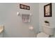 Half bath with a white toilet, art, and towel rack at 8132 Stone Path Way, Tampa, FL 33647
