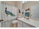 Clean bathroom featuring a peacock themed shower curtain, matching decor, and modern vanity at 8132 Stone Path Way, Tampa, FL 33647