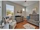 Charming Bedroom features hardwood floors, large windows, and coordinated furniture and decor at 8132 Stone Path Way, Tampa, FL 33647