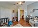 Cozy Bedroom features hardwood floors, ceiling fan, and an open closet with additional decor and storage at 8132 Stone Path Way, Tampa, FL 33647