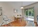 Dining area with hardwood floors, slider to porch, and modern light fixture at 8132 Stone Path Way, Tampa, FL 33647
