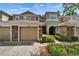 Inviting two-story townhome with stone accents, attached garage, and well-maintained landscaping at 8132 Stone Path Way, Tampa, FL 33647