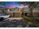 A townhome featuring three units, each with its own garage and driveway at 8132 Stone Path Way, Tampa, FL 33647