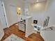 Upstairs hallway with hardwood floors, drawers, a staircase, and neutral walls at 8132 Stone Path Way, Tampa, FL 33647