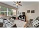 Bright living room with hardwood floors, ceiling fan and a large window allowing natural light at 8132 Stone Path Way, Tampa, FL 33647