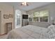 Main bedroom with large windows, ensuite bathroom, and soft carpeting at 8132 Stone Path Way, Tampa, FL 33647