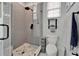 Modern walk-in shower features gray subway tile, dual shower heads, and a decorative tile floor at 8132 Stone Path Way, Tampa, FL 33647