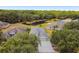 Aerial view of a beautiful home, large backyard, and picturesque pond at 8208 Pinewood Run Ct, Tampa, FL 33647