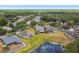 Scenic aerial perspective of residential neighborhood with well-maintained lawns and a tranquil pond at 8208 Pinewood Run Ct, Tampa, FL 33647