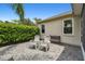 Cozy back patio with brick pavers, two chairs, and privacy landscaping at 8208 Pinewood Run Ct, Tampa, FL 33647