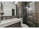 Modern bathroom features a floating vanity, rainfall showerhead, and dark tiled walls, creating a spa-like experience at 8208 Pinewood Run Ct, Tampa, FL 33647