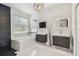 Modern bathroom with dual vanities, a soaking tub, and stylish fixtures at 8208 Pinewood Run Ct, Tampa, FL 33647