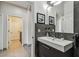 Modern bathroom with floating vanity, stylish mirror, and tiled floor, offering a sleek and functional design at 8208 Pinewood Run Ct, Tampa, FL 33647