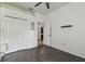 Bedroom with dark hardwood floors, closet, and connected bathroom, offering a blend of comfort and convenience at 8208 Pinewood Run Ct, Tampa, FL 33647