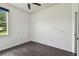 Light and airy bedroom with dark hardwood floors, large window providing natural light, and neutral walls at 8208 Pinewood Run Ct, Tampa, FL 33647