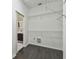 Walk-in closet with wire shelving and hardwood floors, with a view to the en suite bathroom at 8208 Pinewood Run Ct, Tampa, FL 33647