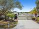 Charming home with a three-car garage and well-manicured landscaping at 8208 Pinewood Run Ct, Tampa, FL 33647