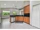 Kitchen with stainless steel dishwasher, wood cabinetry, granite counters, recessed lighting, and large windows at 8208 Pinewood Run Ct, Tampa, FL 33647