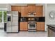 Kitchen features stainless appliances, granite counters, wood cabinets, and tile flooring at 8208 Pinewood Run Ct, Tampa, FL 33647