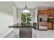 Kitchen island features a sleek design, stainless steel appliances and wooden cabinets creating a modern, functional space at 8208 Pinewood Run Ct, Tampa, FL 33647
