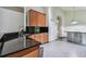 Beautiful kitchen featuring granite counters, wood cabinets, stainless steel appliances, and tile floors at 8208 Pinewood Run Ct, Tampa, FL 33647