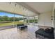Spacious screened lanai featuring stylish pallet seating and views of the tranquil backyard pond at 8208 Pinewood Run Ct, Tampa, FL 33647