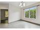 Bright living area showcasing tile flooring and large windows with views of lush landscaping at 8208 Pinewood Run Ct, Tampa, FL 33647