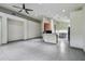 Open-concept living space with neutral tile flooring and view to the kitchen at 8208 Pinewood Run Ct, Tampa, FL 33647