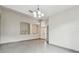 Well-lit living room featuring tile flooring, arched niches, and a view of the front entrance at 8208 Pinewood Run Ct, Tampa, FL 33647