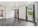 Bright living room with hardwood floors, a modern chandelier, and lots of natural light at 8208 Pinewood Run Ct, Tampa, FL 33647