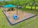 Playground with swings and a blue hippo set within a bark-mulched area, perfect for to explore at 8208 Pinewood Run Ct, Tampa, FL 33647