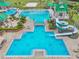 Overhead view of community pool with a winding waterslide, a splash pad, lap lanes, and seating at 8208 Pinewood Run Ct, Tampa, FL 33647