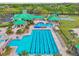 Overhead view of the community pool, which features a slide, splash pad, lap lanes, and plenty of seating at 8208 Pinewood Run Ct, Tampa, FL 33647