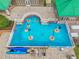 A bright blue splash pad with colorful water features provides a fun zone for at the community pool at 8208 Pinewood Run Ct, Tampa, FL 33647