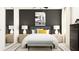 Stylish bedroom with a comfortable bed, nightstands with lamps, and a monochrome art piece creates a serene atmosphere at 8904 Gulf Shore Ter, Parrish, FL 34219