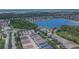 Aerial view of a neighborhood with a lake, community pool, and rows of homes at 9023 Sienna Moss Ln, Riverview, FL 33578