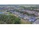Aerial view of a home in a residential neighborhood with a pond and mature trees at 9023 Sienna Moss Ln, Riverview, FL 33578