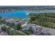 Aerial view of a home in a residential neighborhood with a lake view and mature trees at 9023 Sienna Moss Ln, Riverview, FL 33578