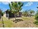 Backyard featuring a screened porch, green space, and mature trees at 9023 Sienna Moss Ln, Riverview, FL 33578