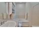 Bright bathroom featuring a tub and shower combo, sink, and built-in shelving for extra storage at 9023 Sienna Moss Ln, Riverview, FL 33578