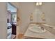 Bathroom showcases double sinks with chrome faucets, a large mirror, and access to the bedroom at 9023 Sienna Moss Ln, Riverview, FL 33578