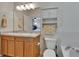 Bathroom features dual sinks, cabinets, large mirrors, and a bathtub/shower combo with white tiling at 9023 Sienna Moss Ln, Riverview, FL 33578