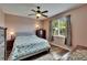 Bright bedroom with hardwood floors, large window, a ceiling fan, and patterned curtains at 9023 Sienna Moss Ln, Riverview, FL 33578